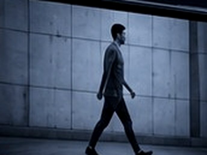A camera frame of a person walking — the short walking video or CCTV clip the pipeline starts from, with the first pose markers picked out.